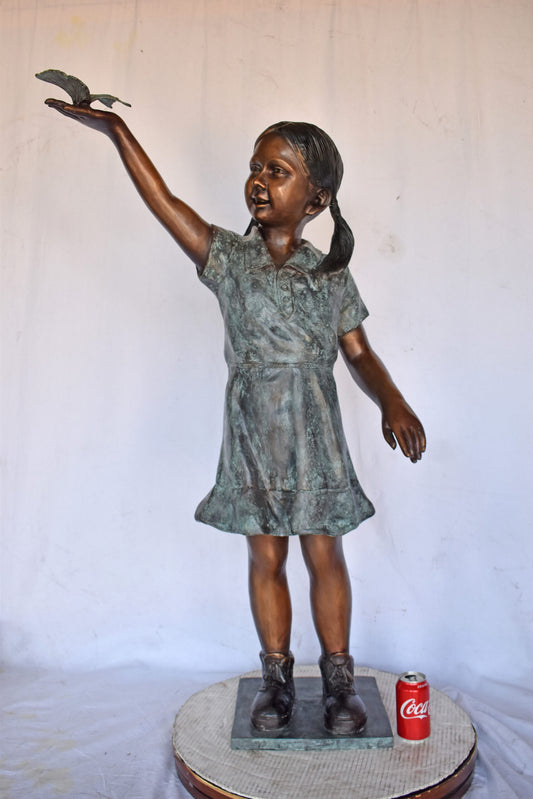 Young Girl Holding a Butterfly Outside at The Park - Size: 21"L x 11"W x 49"H.