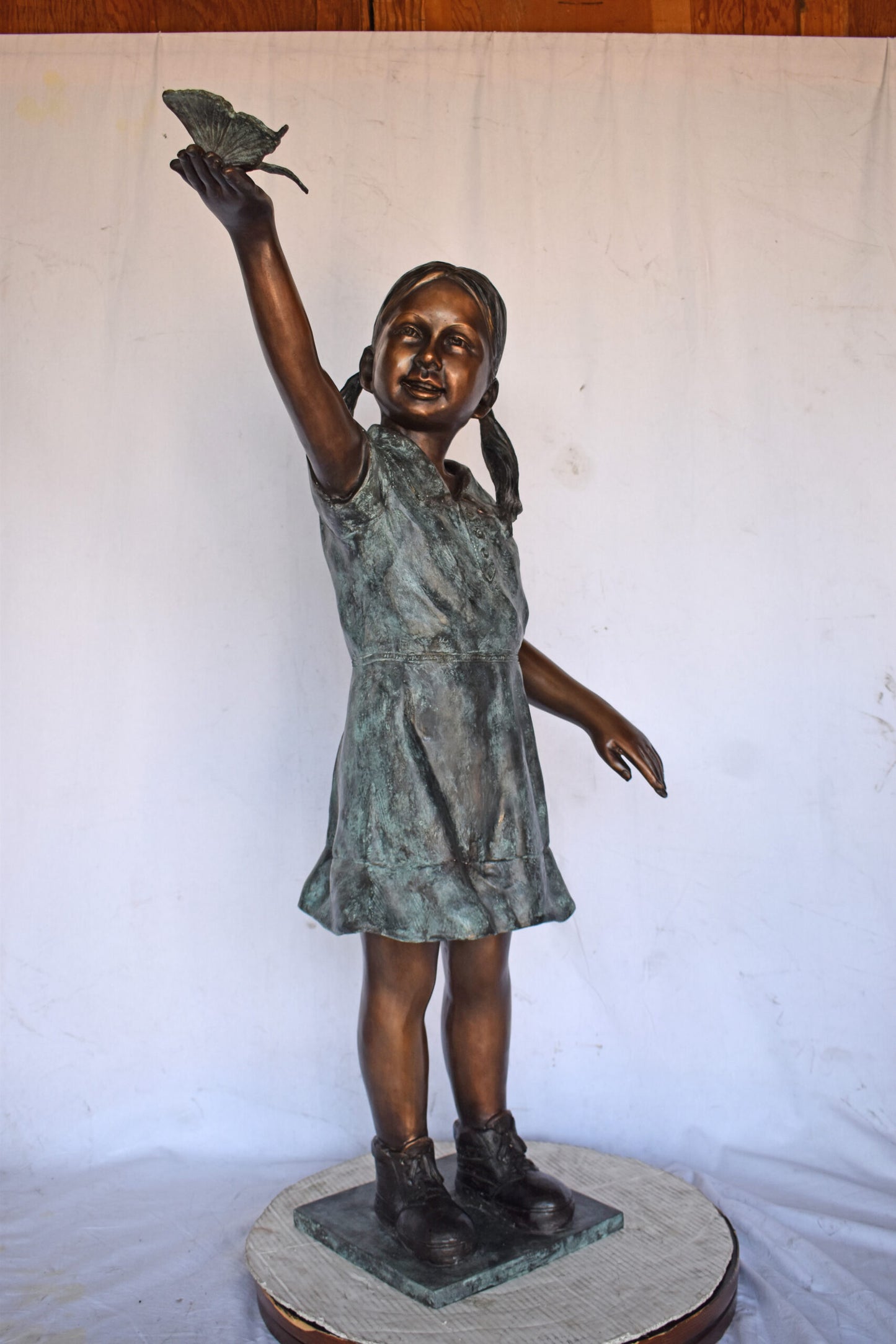 Young Girl Holding a Butterfly Outside at The Park - Size: 21"L x 11"W x 49"H.