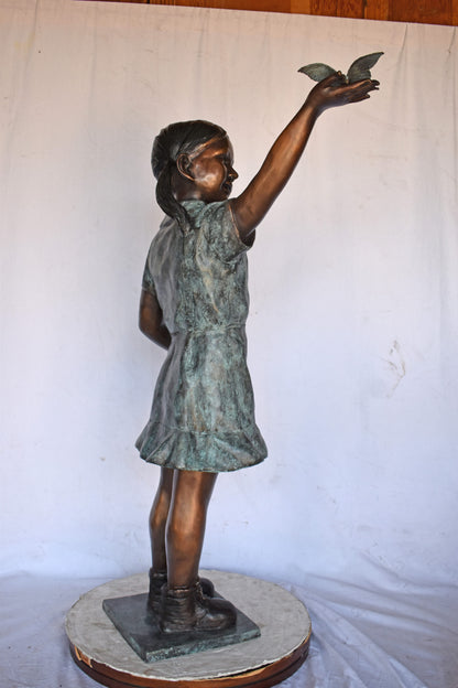 Young Girl Holding a Butterfly Outside at The Park - Size: 21"L x 11"W x 49"H.