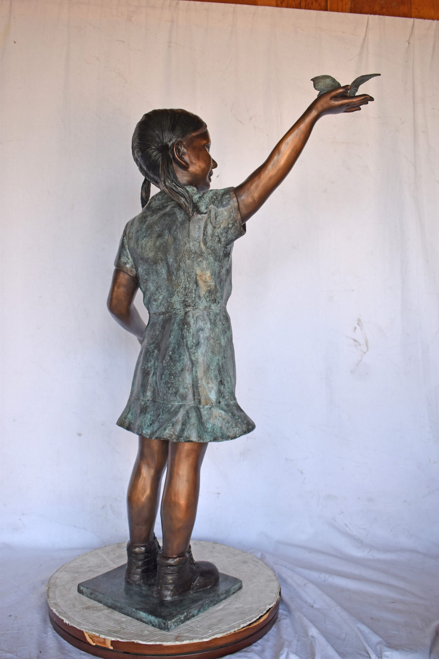 Young Girl Holding a Butterfly Outside at The Park - Size: 21"L x 11"W x 49"H.