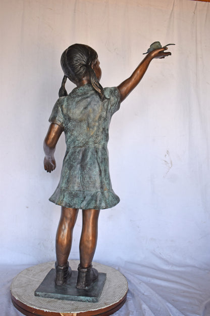 Young Girl Holding a Butterfly Outside at The Park - Size: 21"L x 11"W x 49"H.