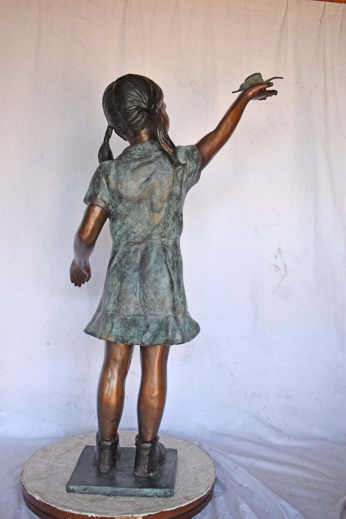 Young Girl Holding a Butterfly Outside at The Park - Size: 21"L x 11"W x 49"H.