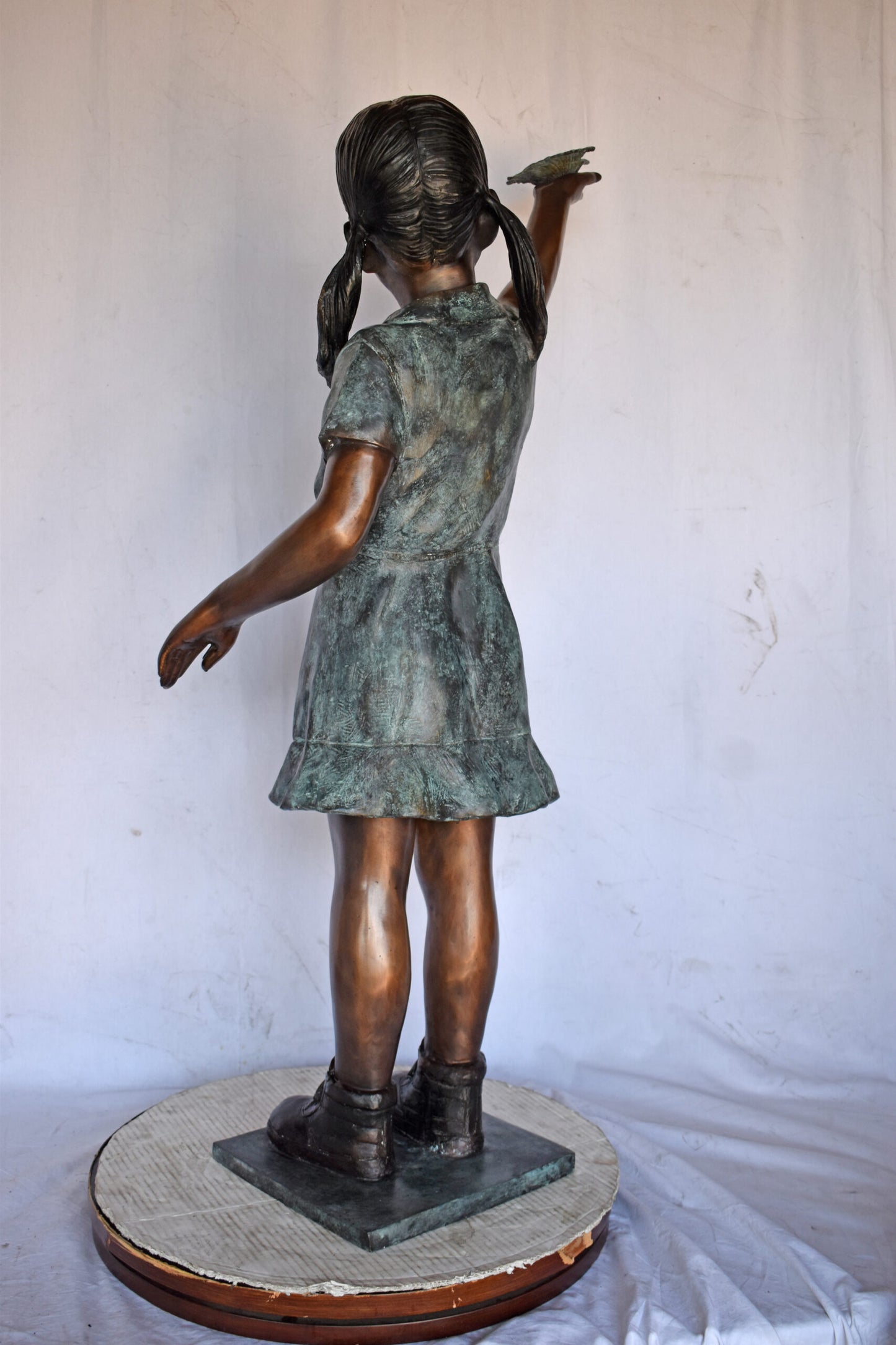 Young Girl Holding a Butterfly Outside at The Park - Size: 21"L x 11"W x 49"H.