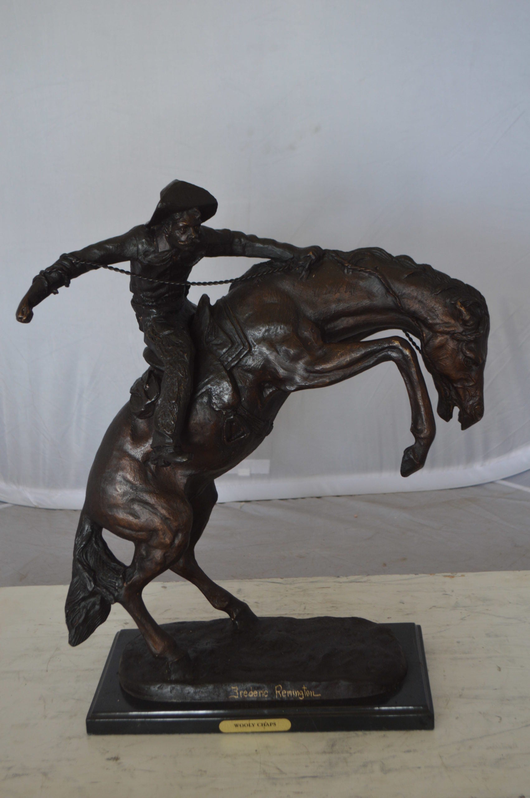 Wooly Chaps Bronze Statue by Remington -  Size: 19"L x 11"W x 23"H. 