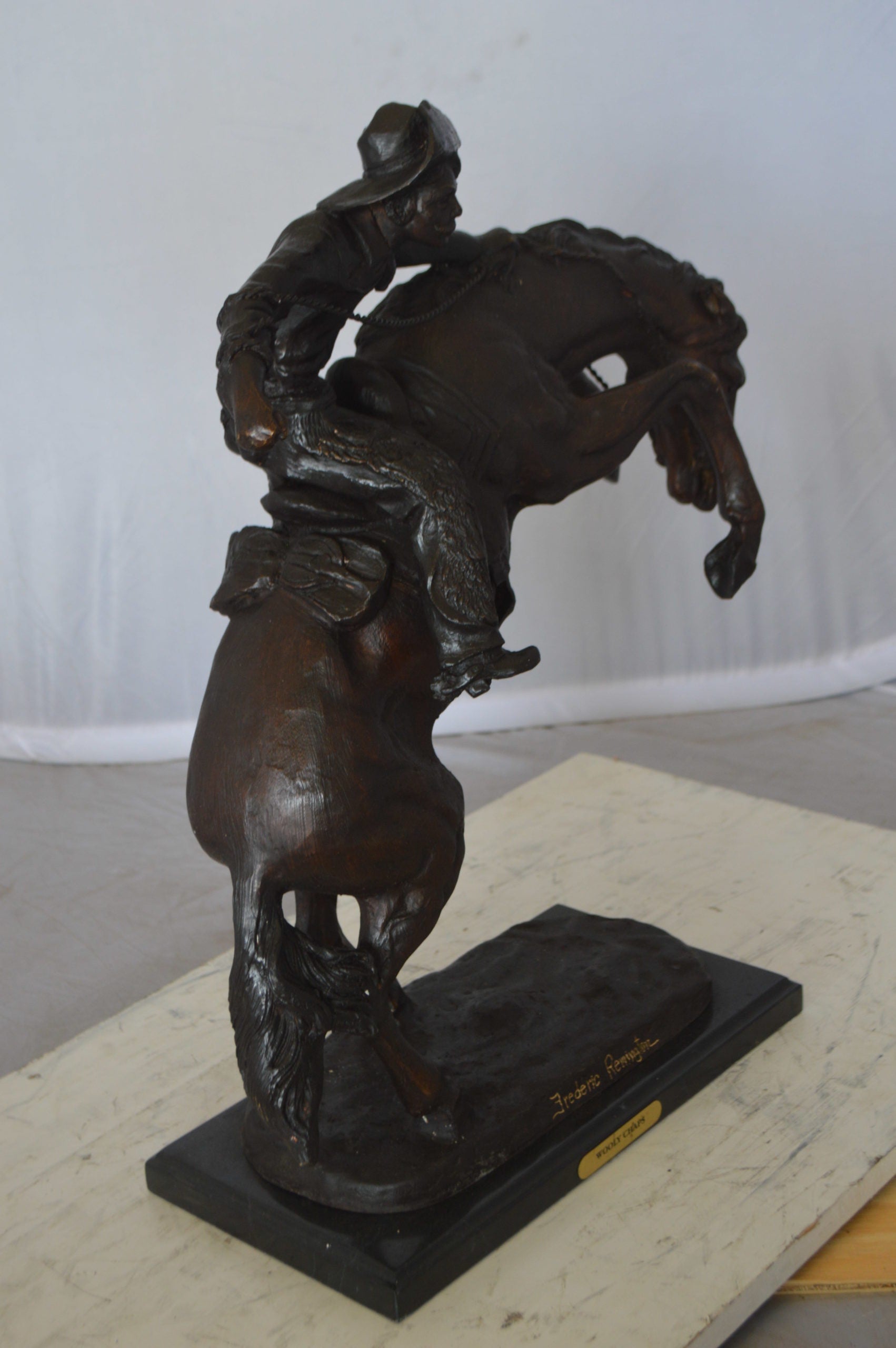 Wooly Chaps Bronze Statue by Remington -  Size: 19"L x 11"W x 23"H. 
