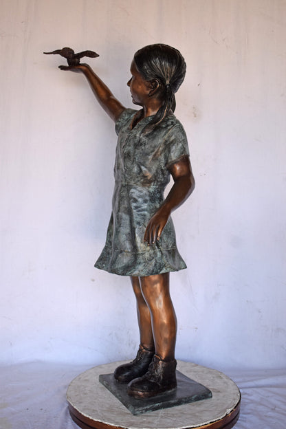 Young Girl Holding a Bird Outside at The Park - Size: 21"L x 11"W x 49"H.