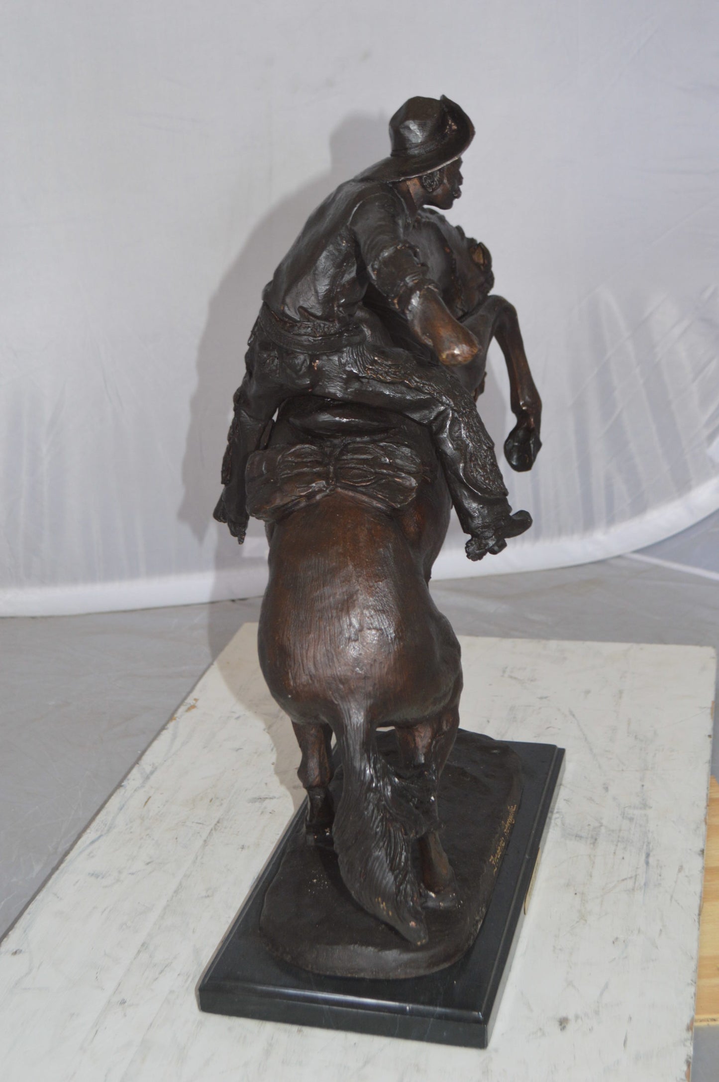 Wooly Chaps Bronze Statue by Remington -  Size: 19"L x 11"W x 23"H. 