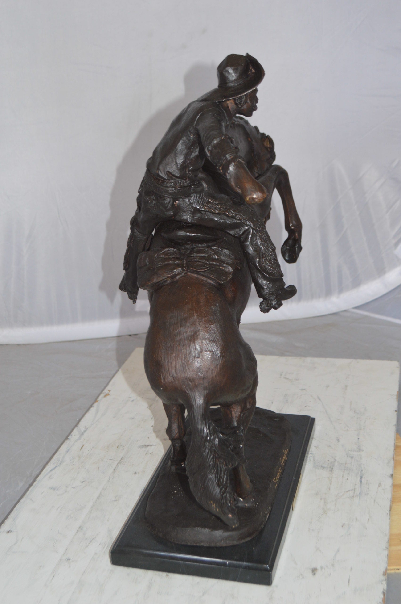 Wooly Chaps Bronze Statue by Remington -  Size: 19"L x 11"W x 23"H. 