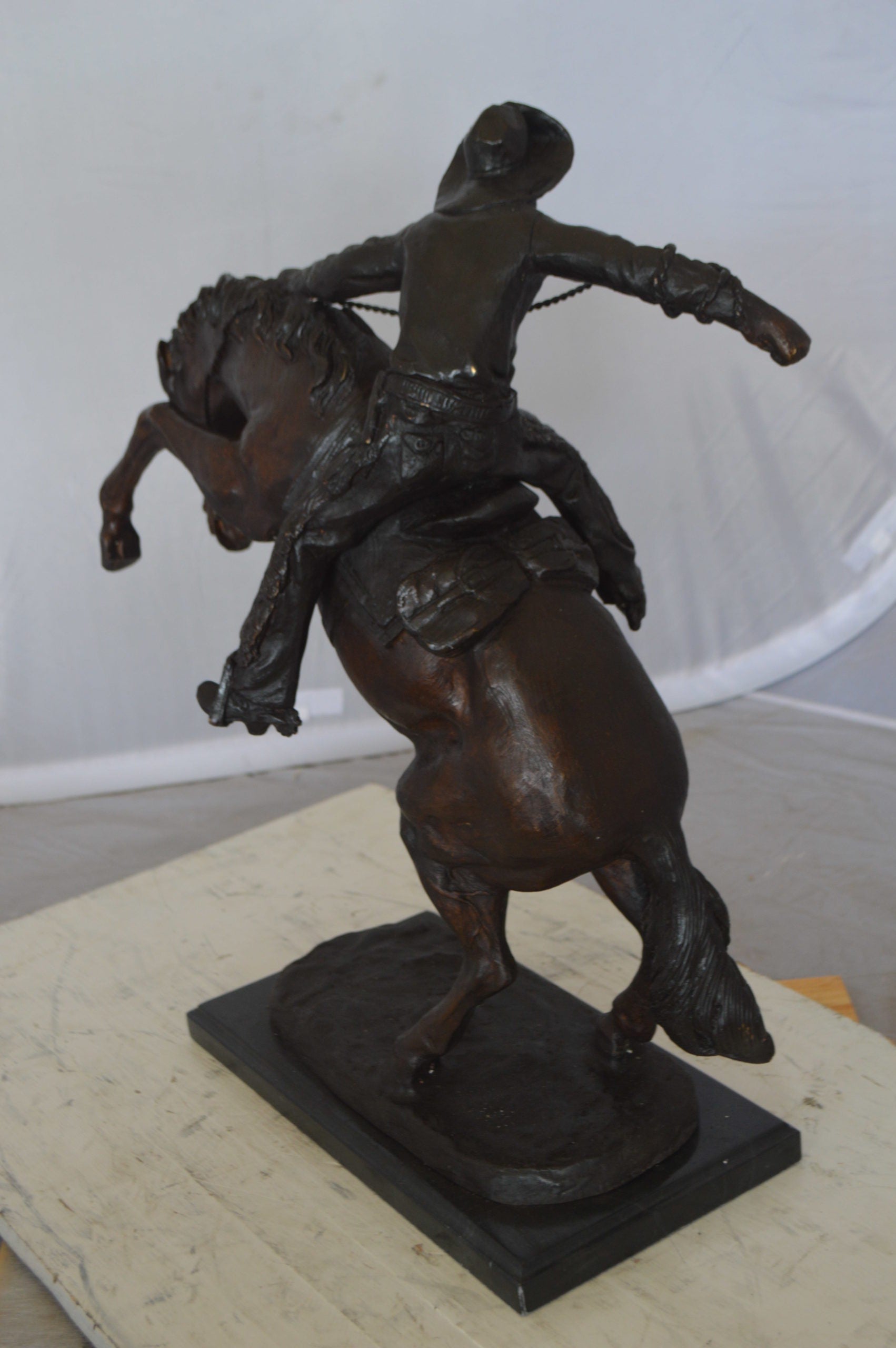 Wooly Chaps Bronze Statue by Remington -  Size: 19"L x 11"W x 23"H. 