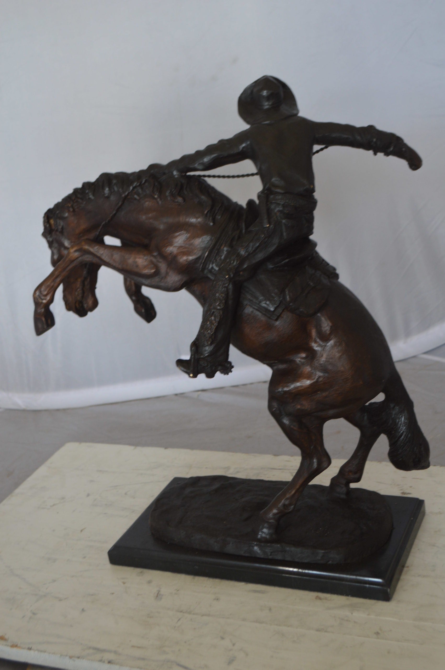 Wooly Chaps Bronze Statue by Remington -  Size: 19"L x 11"W x 23"H. 