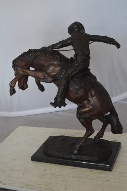 Wooly Chaps Bronze Statue by Remington -  Size: 19"L x 11"W x 23"H. 