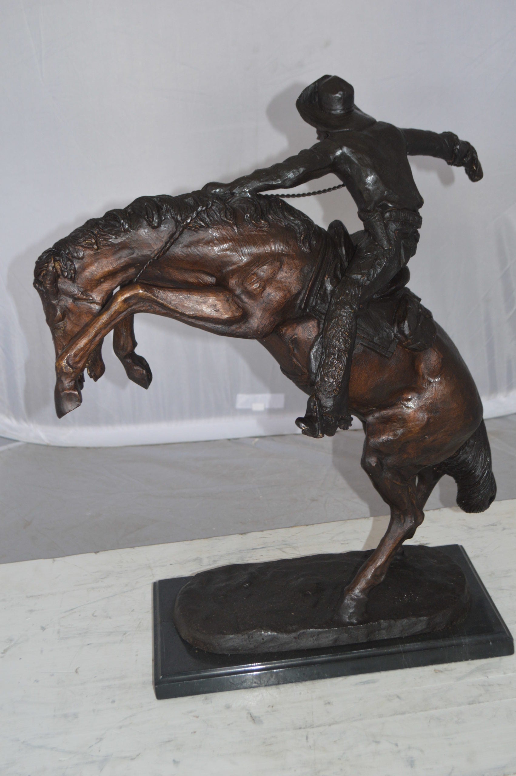 Wooly Chaps Bronze Statue by Remington -  Size: 19"L x 11"W x 23"H. 