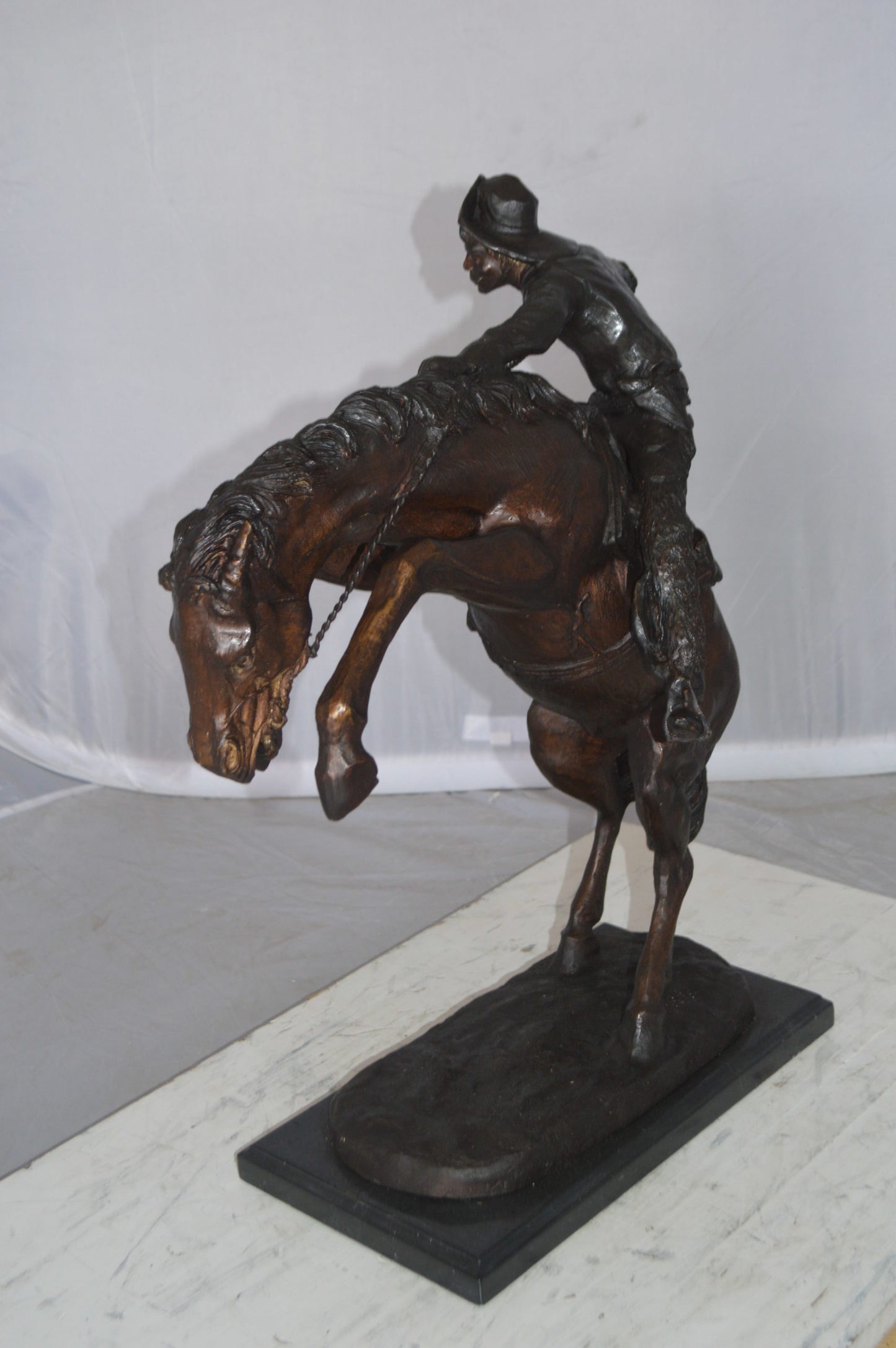 Wooly Chaps Bronze Statue by Remington -  Size: 19"L x 11"W x 23"H. 