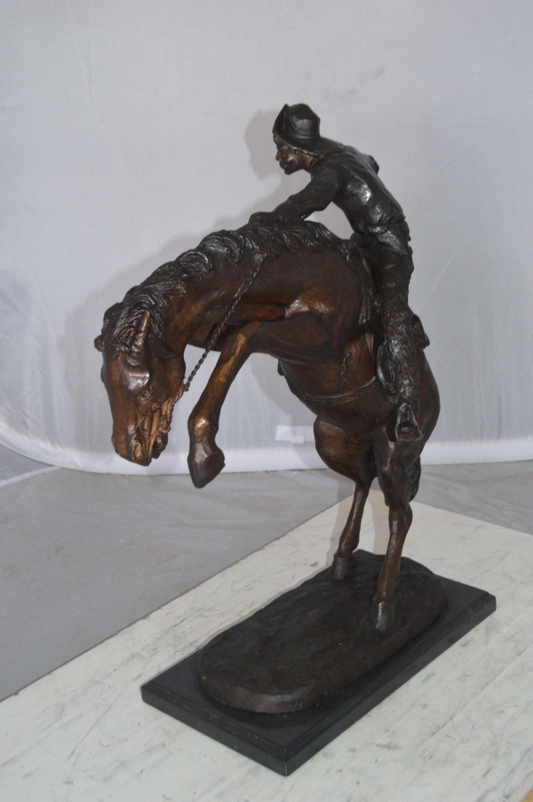 Wooly Chaps Bronze Statue by Remington -  Size: 19"L x 11"W x 23"H. 
