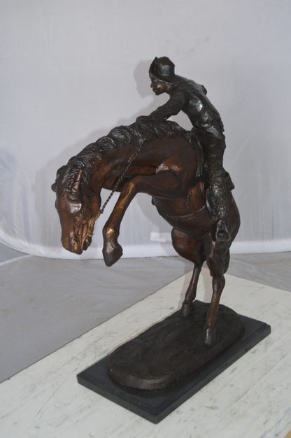 Wooly Chaps Bronze Statue by Remington -  Size: 19"L x 11"W x 23"H. 