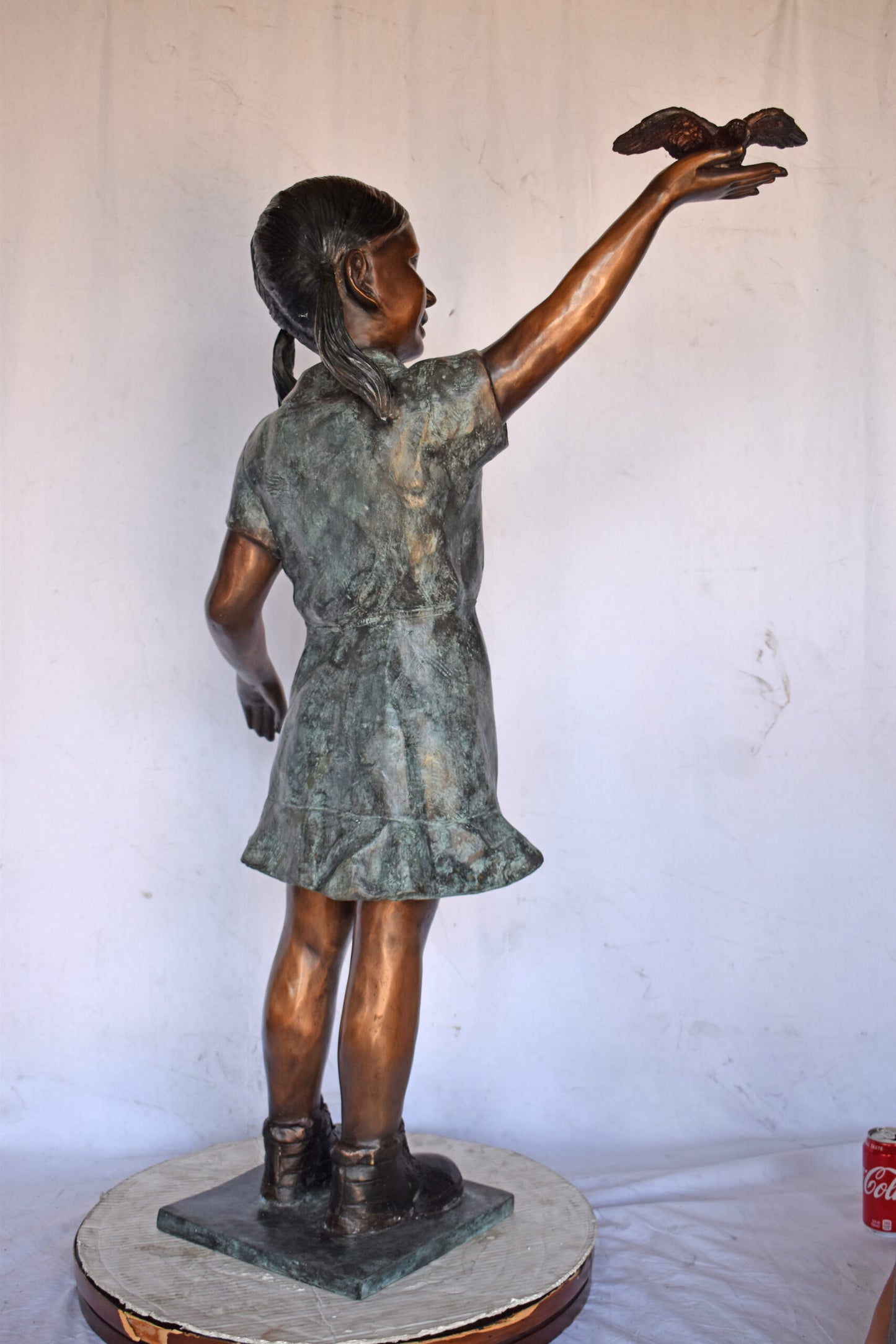 Young Girl Holding a Bird Outside at The Park - Size: 21"L x 11"W x 49"H.