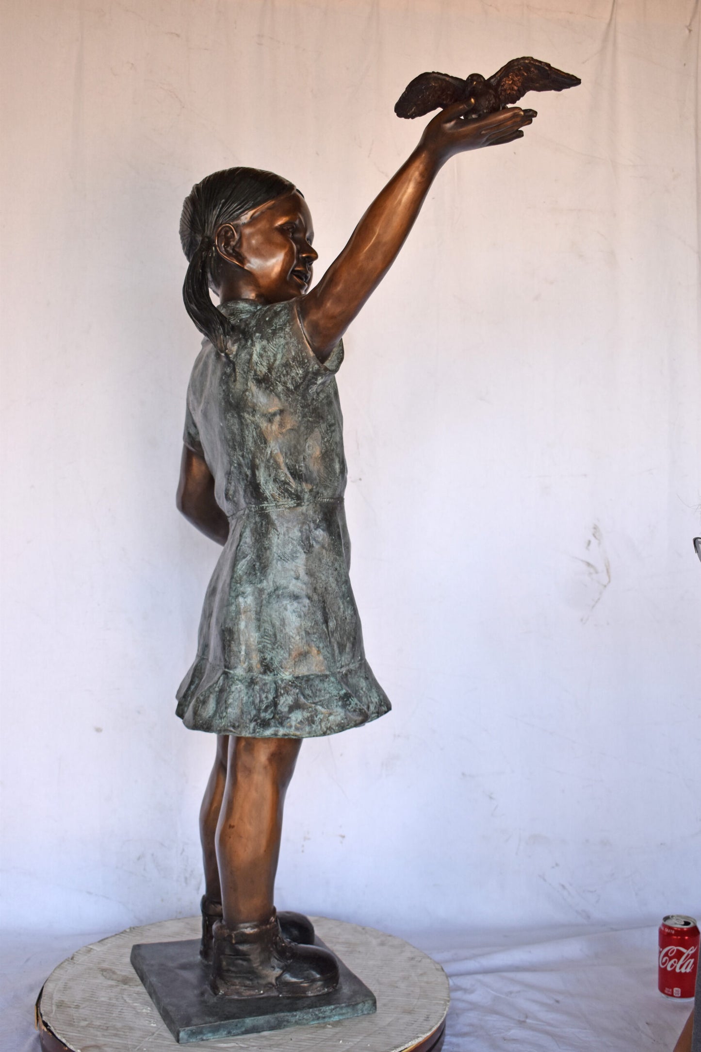 Young Girl Holding a Bird Outside at The Park - Size: 21"L x 11"W x 49"H.
