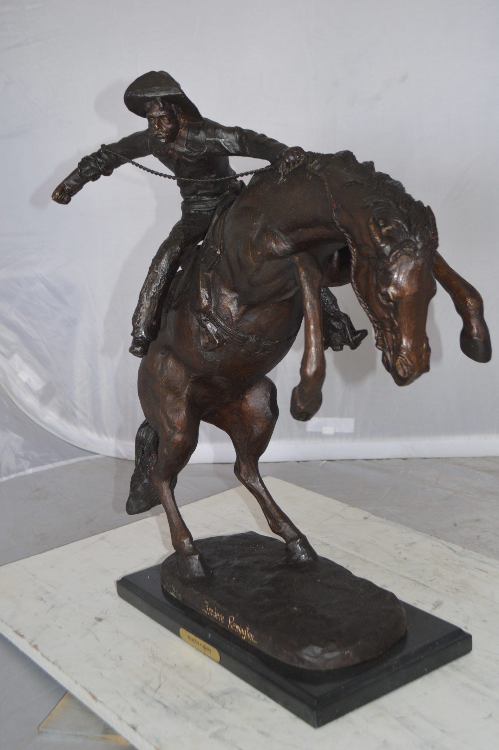 Wooly Chaps Bronze Statue by Remington -  Size: 19"L x 11"W x 23"H. 