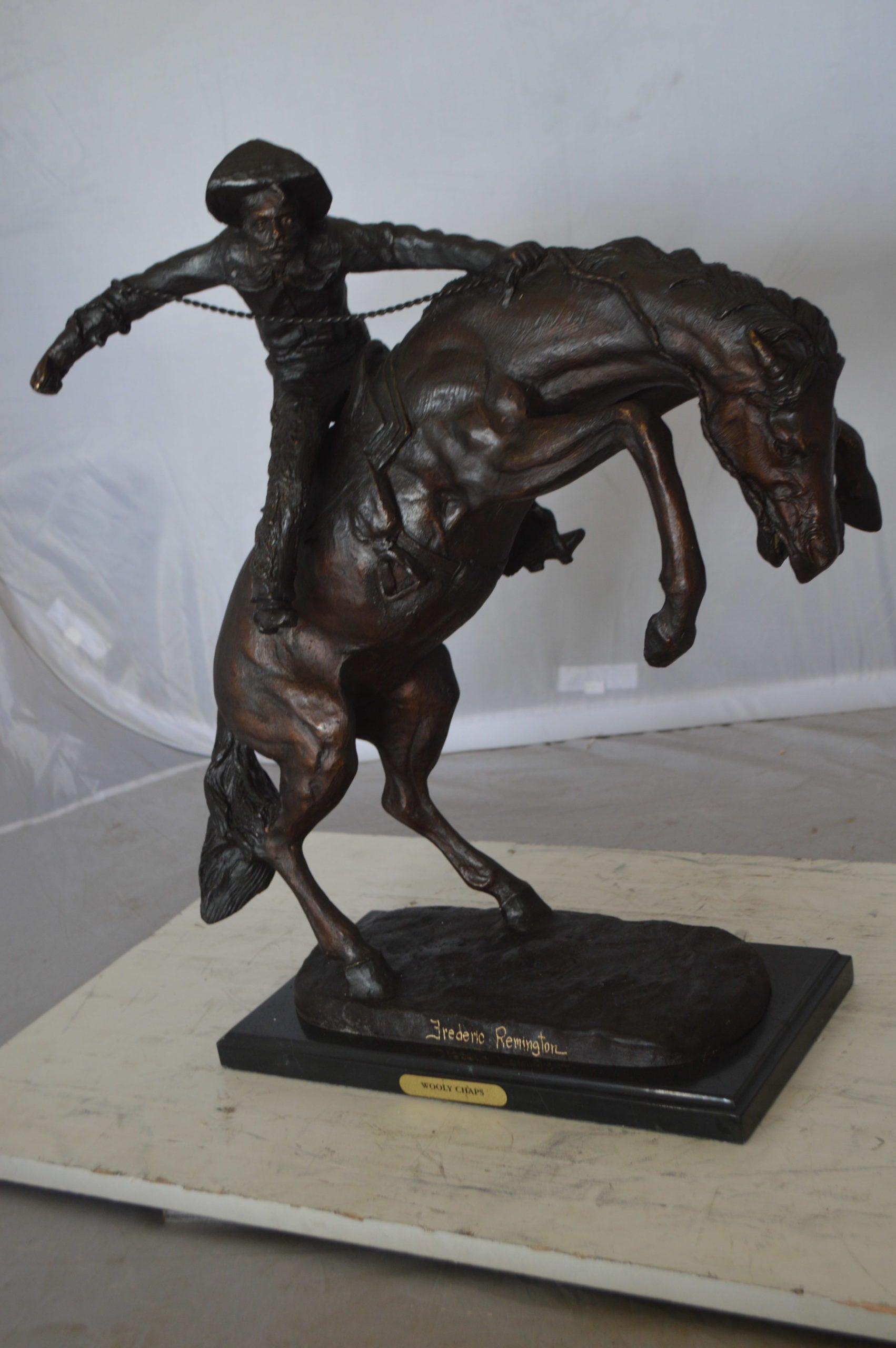 Wooly Chaps Bronze Statue by Remington -  Size: 19"L x 11"W x 23"H. 