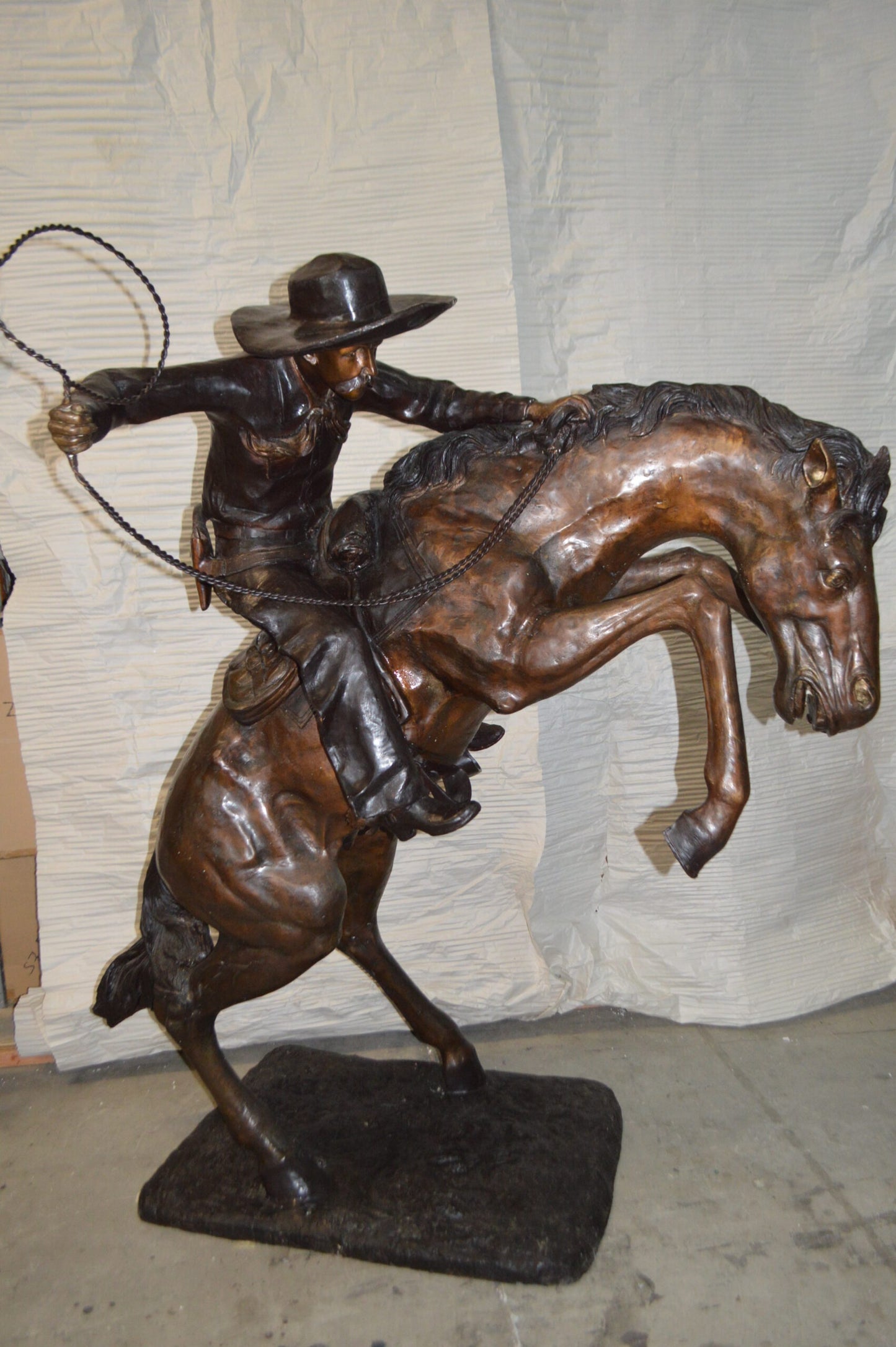 Bronco Buster Giant Bronze Statue -  Size: 65"L x 52"W x 64"H.