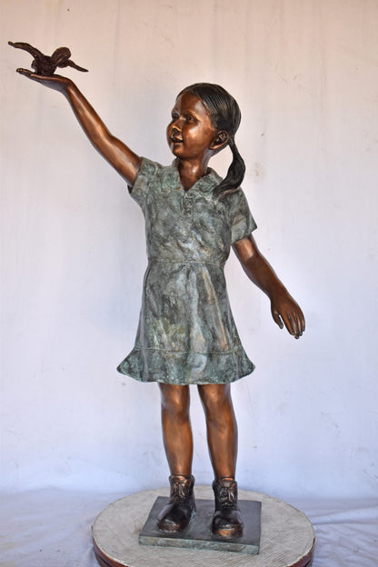 Young Girl Holding a Bird Outside at The Park - Size: 21"L x 11"W x 49"H.