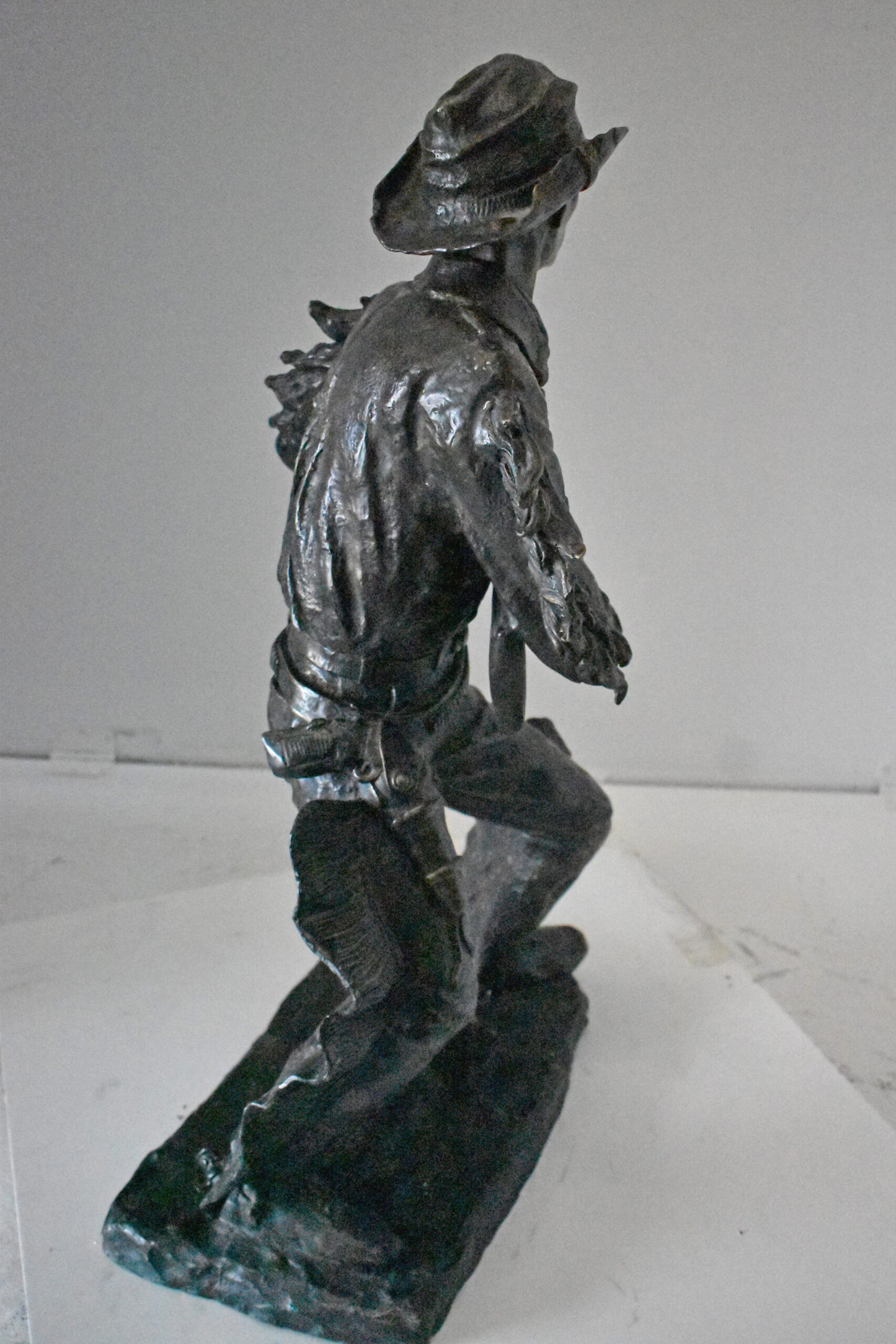 Cowboy with His Gun Bronze Statue - Size: 26"L x 13"W x 33"H.