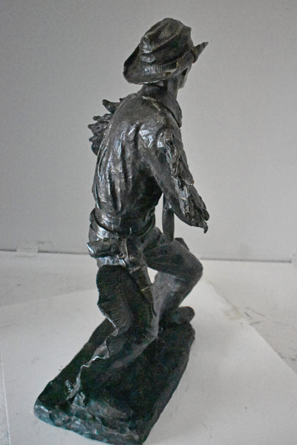 Cowboy with His Gun Bronze Statue - Size: 26"L x 13"W x 33"H.
