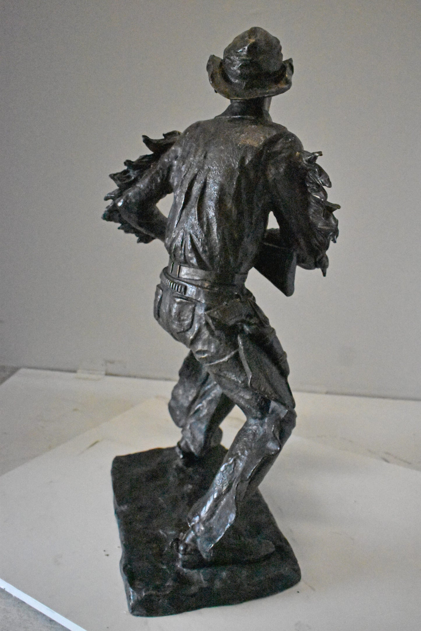 Cowboy with His Gun Bronze Statue - Size: 26"L x 13"W x 33"H.