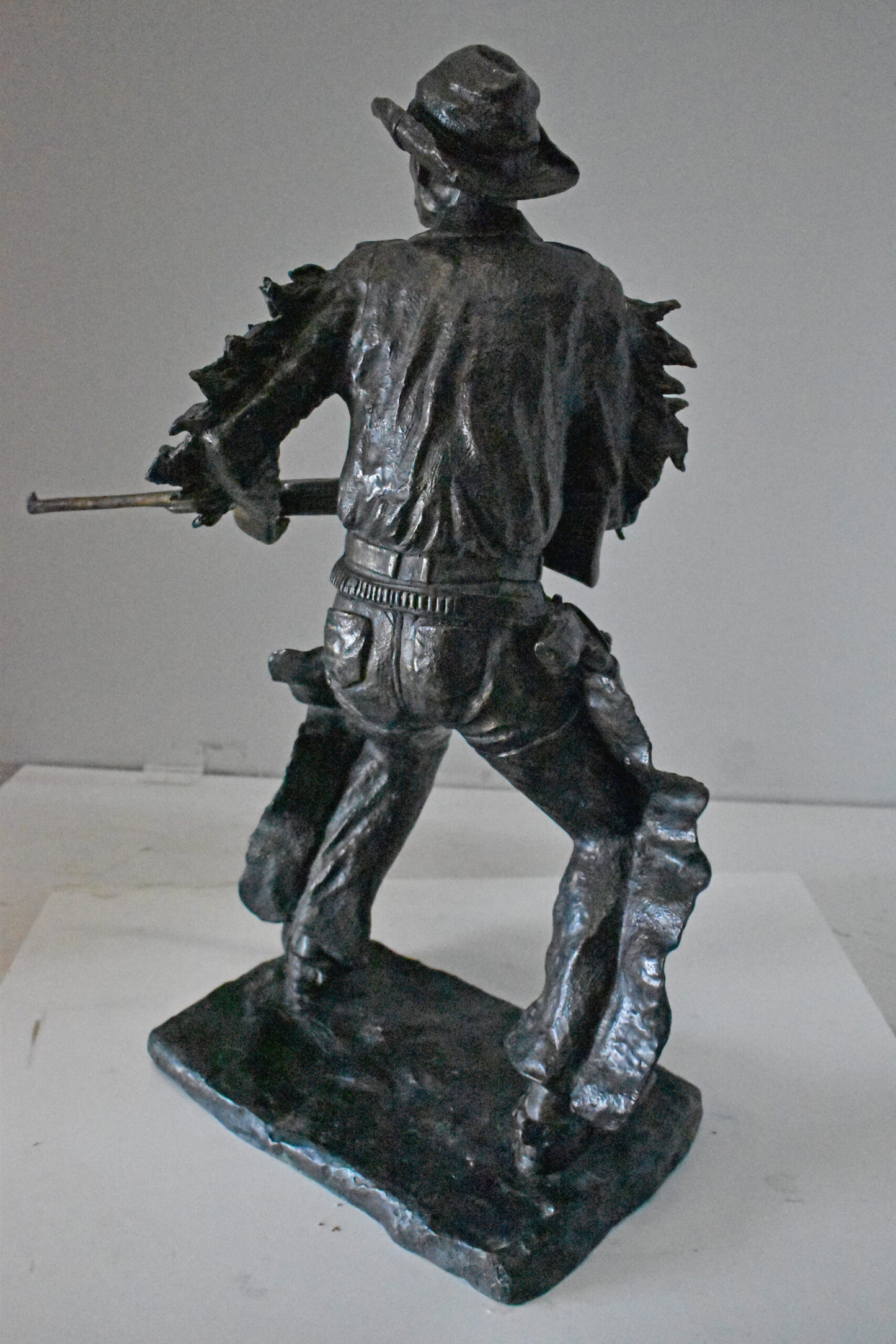 Cowboy with His Gun Bronze Statue - Size: 26"L x 13"W x 33"H.