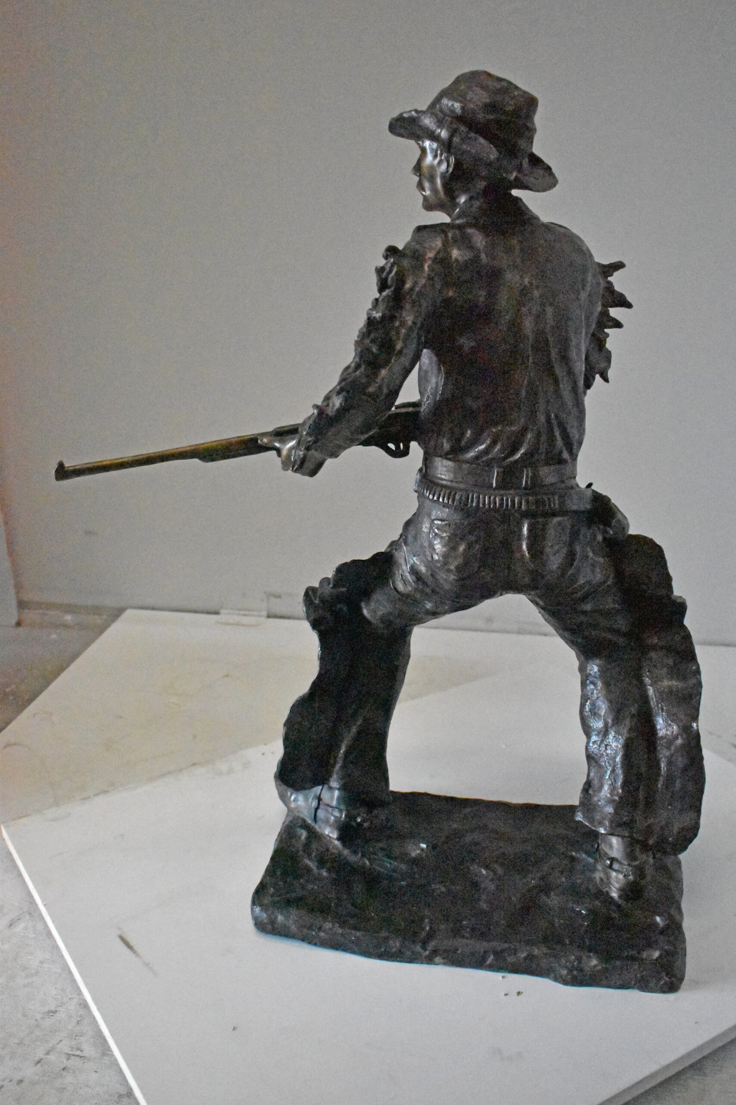 Cowboy with His Gun Bronze Statue - Size: 26"L x 13"W x 33"H.