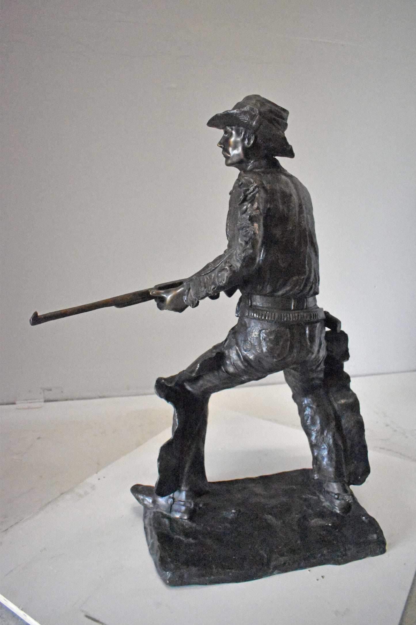 Cowboy with His Gun Bronze Statue - Size: 26"L x 13"W x 33"H.