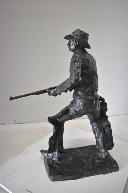 Cowboy with His Gun Bronze Statue - Size: 26"L x 13"W x 33"H.