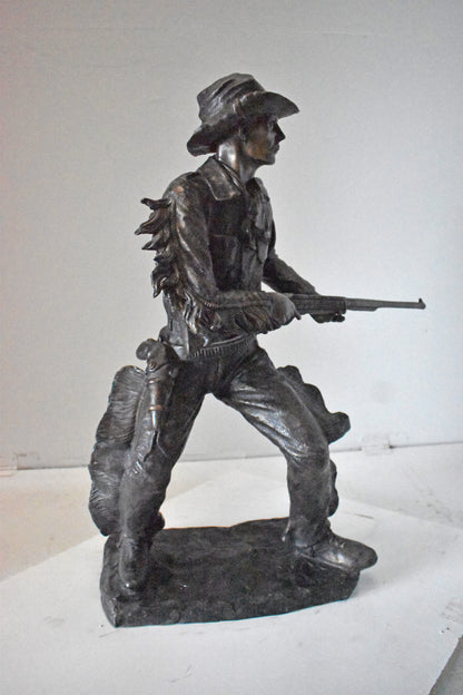 Cowboy with His Gun Bronze Statue - Size: 26"L x 13"W x 33"H.