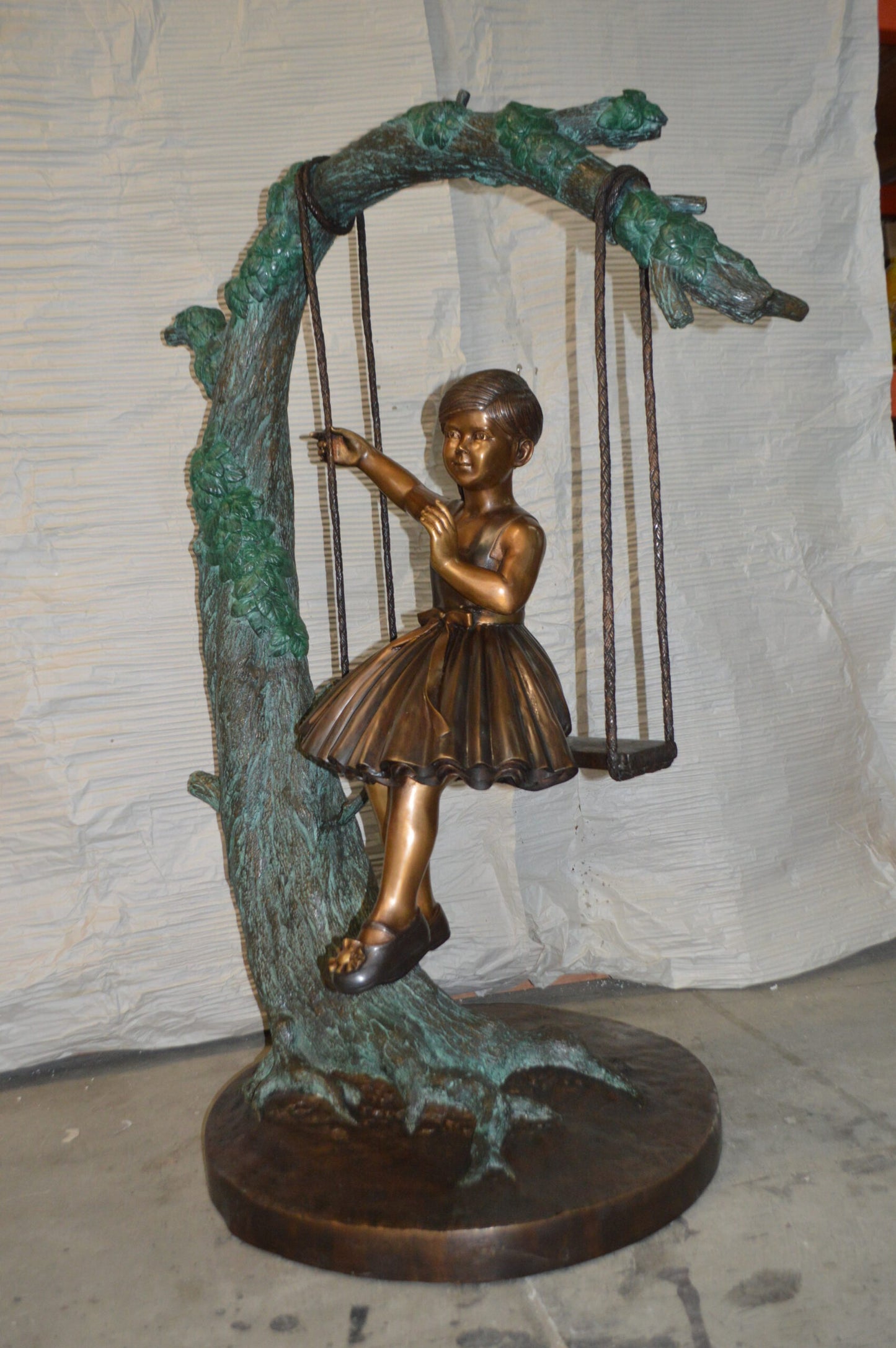 Girl on Swing 65 Bronze Statue -  Size: 44"L x 35"W x 65"H.
