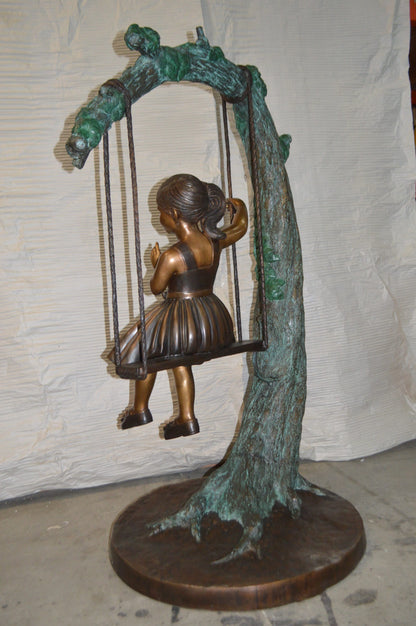 Girl on Swing 65 Bronze Statue -  Size: 44"L x 35"W x 65"H.