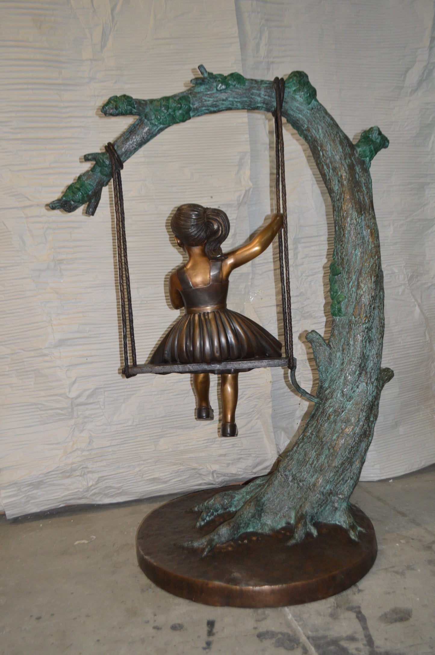 Girl on Swing 65 Bronze Statue -  Size: 44"L x 35"W x 65"H.