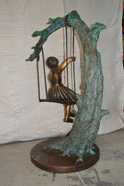 Girl on Swing 65 Bronze Statue -  Size: 44"L x 35"W x 65"H.