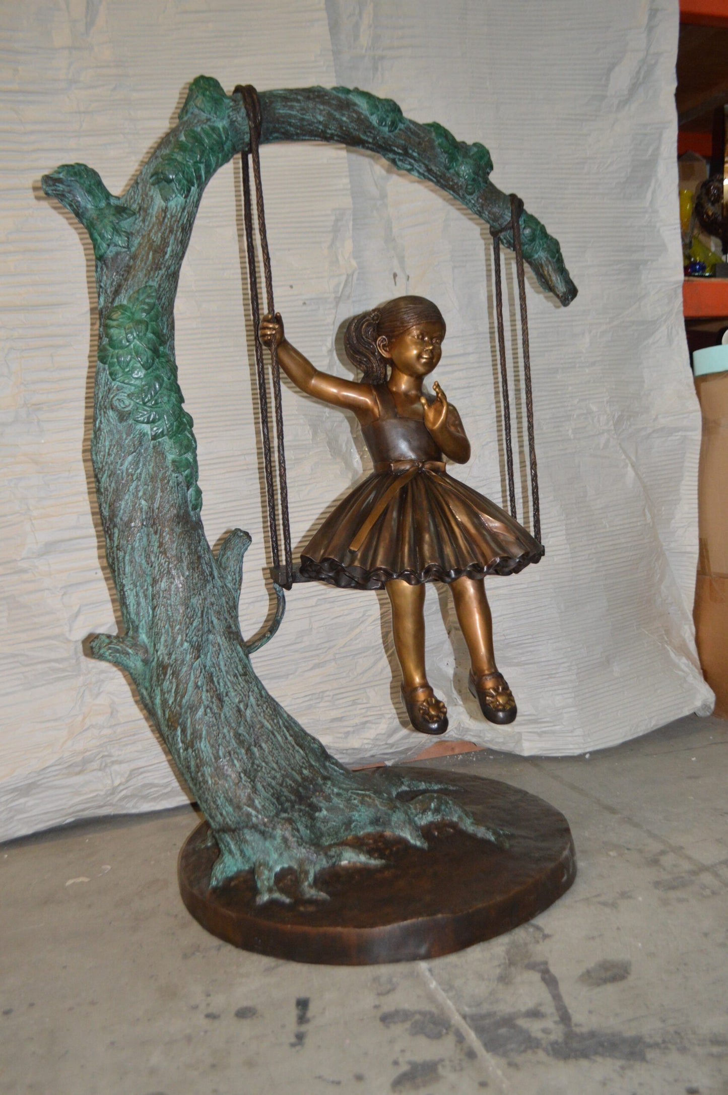 Girl on Swing 65 Bronze Statue -  Size: 44"L x 35"W x 65"H.