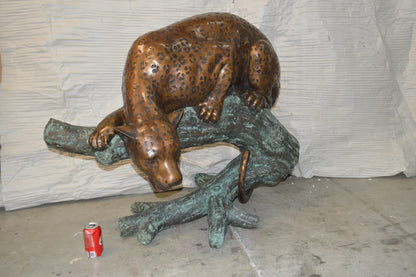 Leopard on a Tree Trunk Bronze Statue -  Size: 38"L x 34"W x 36"H.