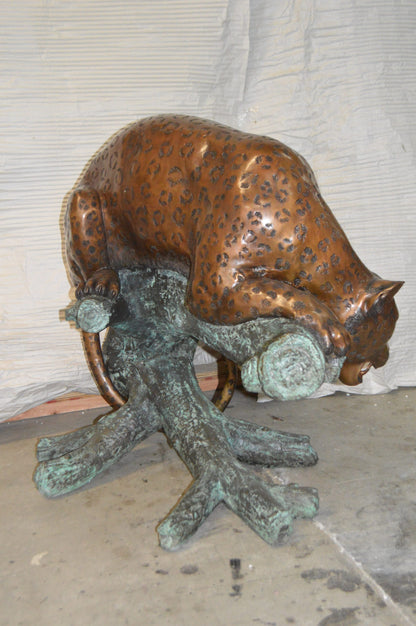 Leopard on a Tree Trunk Bronze Statue -  Size: 38"L x 34"W x 36"H.