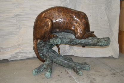 Leopard on a Tree Trunk Bronze Statue -  Size: 38"L x 34"W x 36"H.