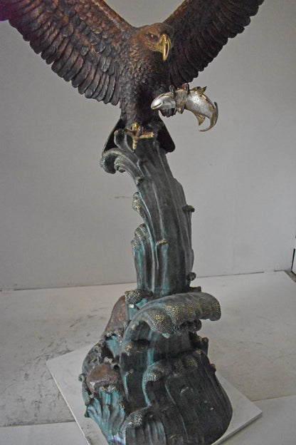 Eagle in Action Catching His Prey Bronze Statue - Size: 68"L x 40"W x 87"H.