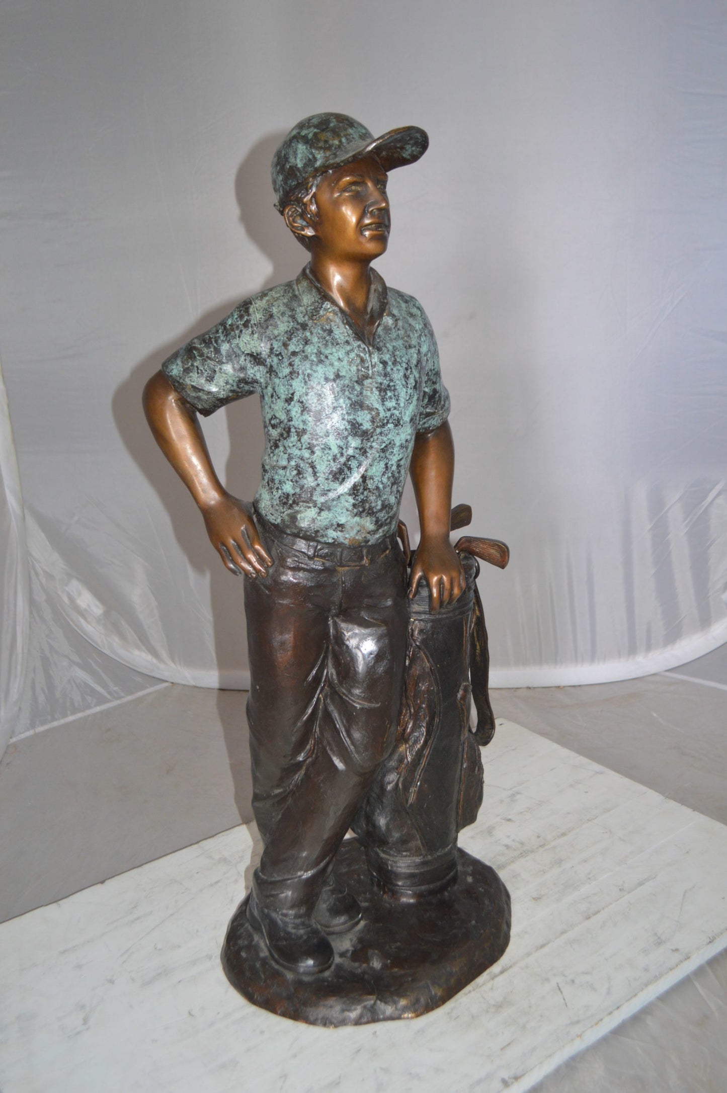 Golfer with bag Bronze Statue -  Size: 12"L x 13"W x 32"H. 