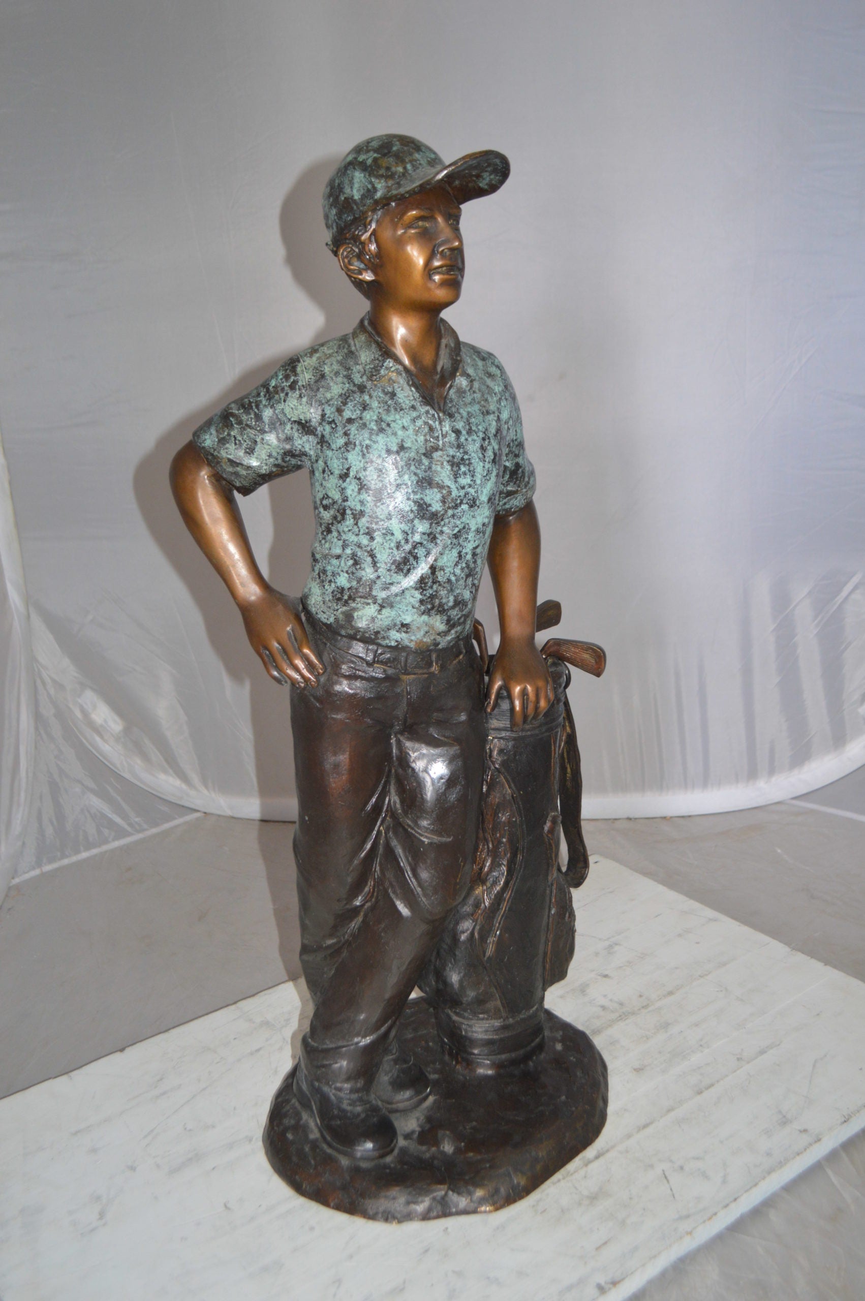 Golfer with bag Bronze Statue -  Size: 12"L x 13"W x 32"H. 