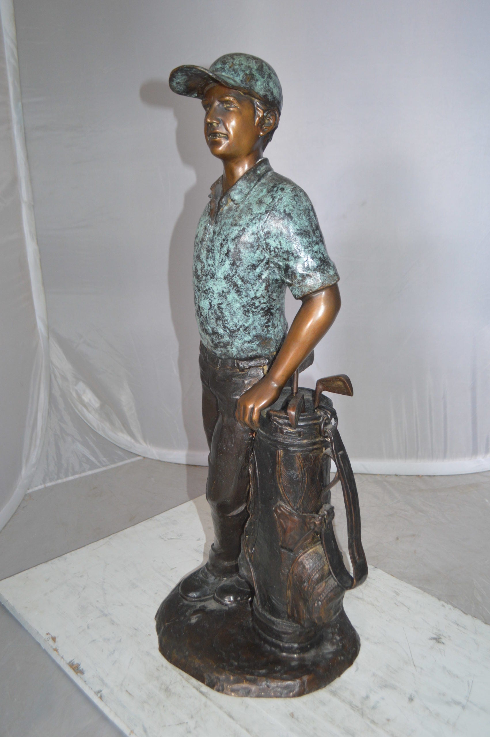 Golfer with bag Bronze Statue -  Size: 12"L x 13"W x 32"H. 