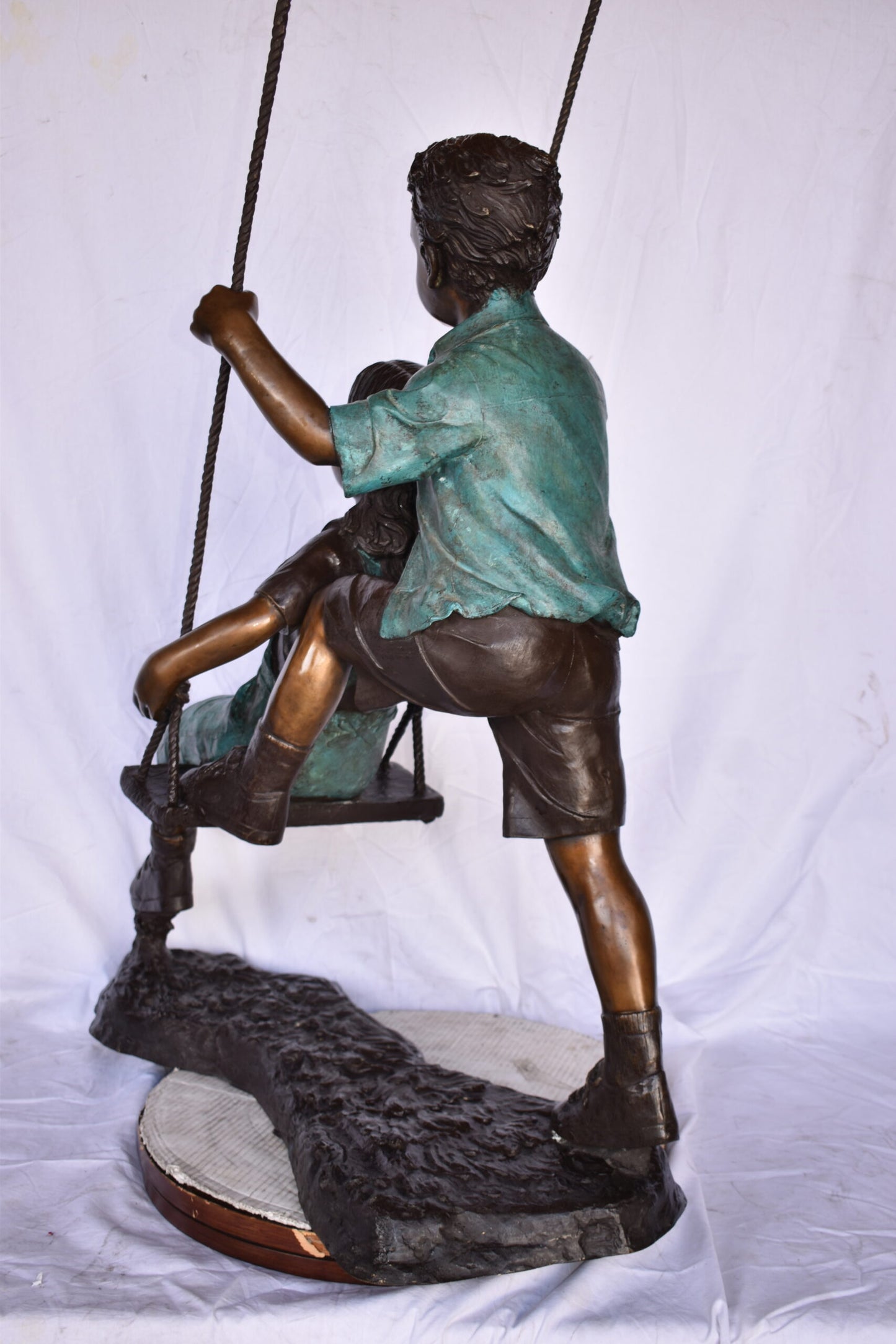 Boy and Girl Playing on a Swing bronze Statue - Size: 39"L x 17"W x 53"H.