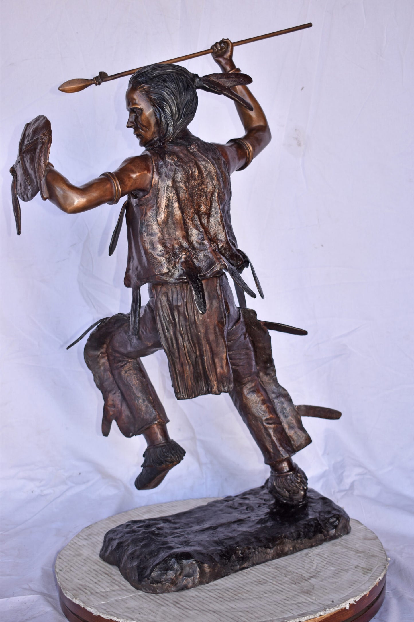 Indian Worrier Throwing a Spear Bronze Statue - Size: 15"L x 23"W x 38"H.