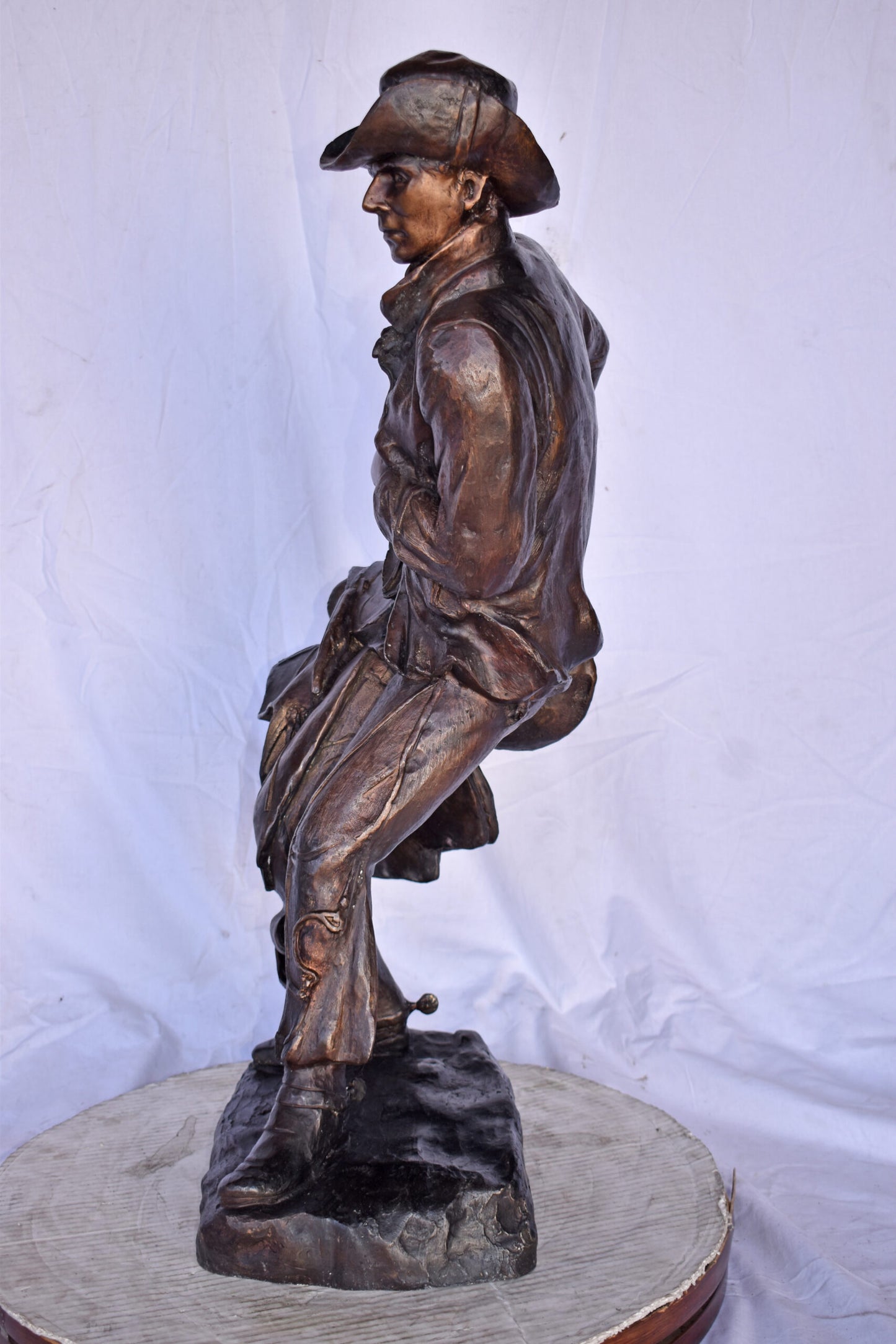 Cowboy Holding His Saddle Bronze Statue - Size: 20"L x 14"W x 35"H.