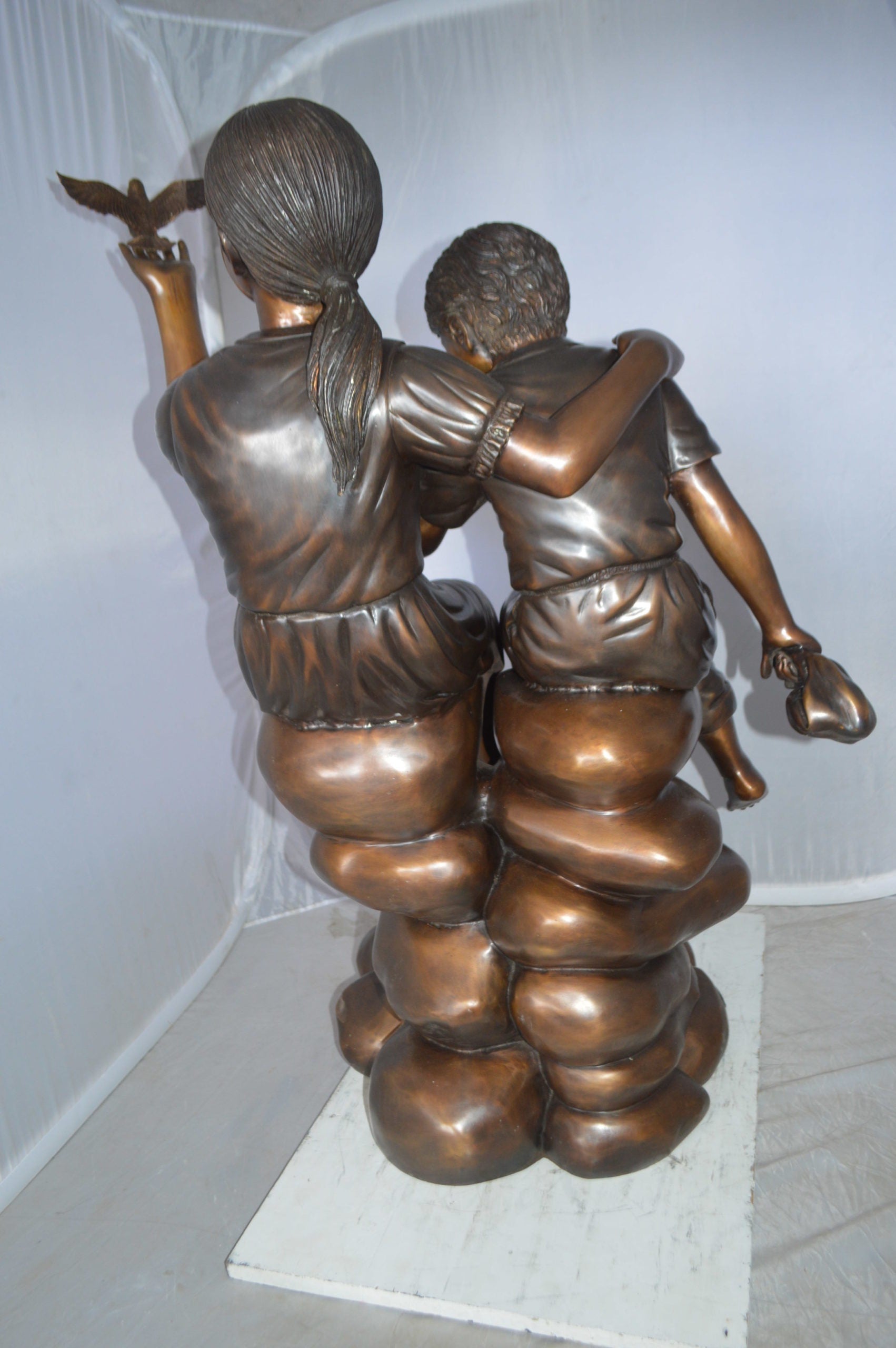 Two Kids on Rocks with a Bird Bronze Statue -  Size: 36"L x 30"W x 44"H. 