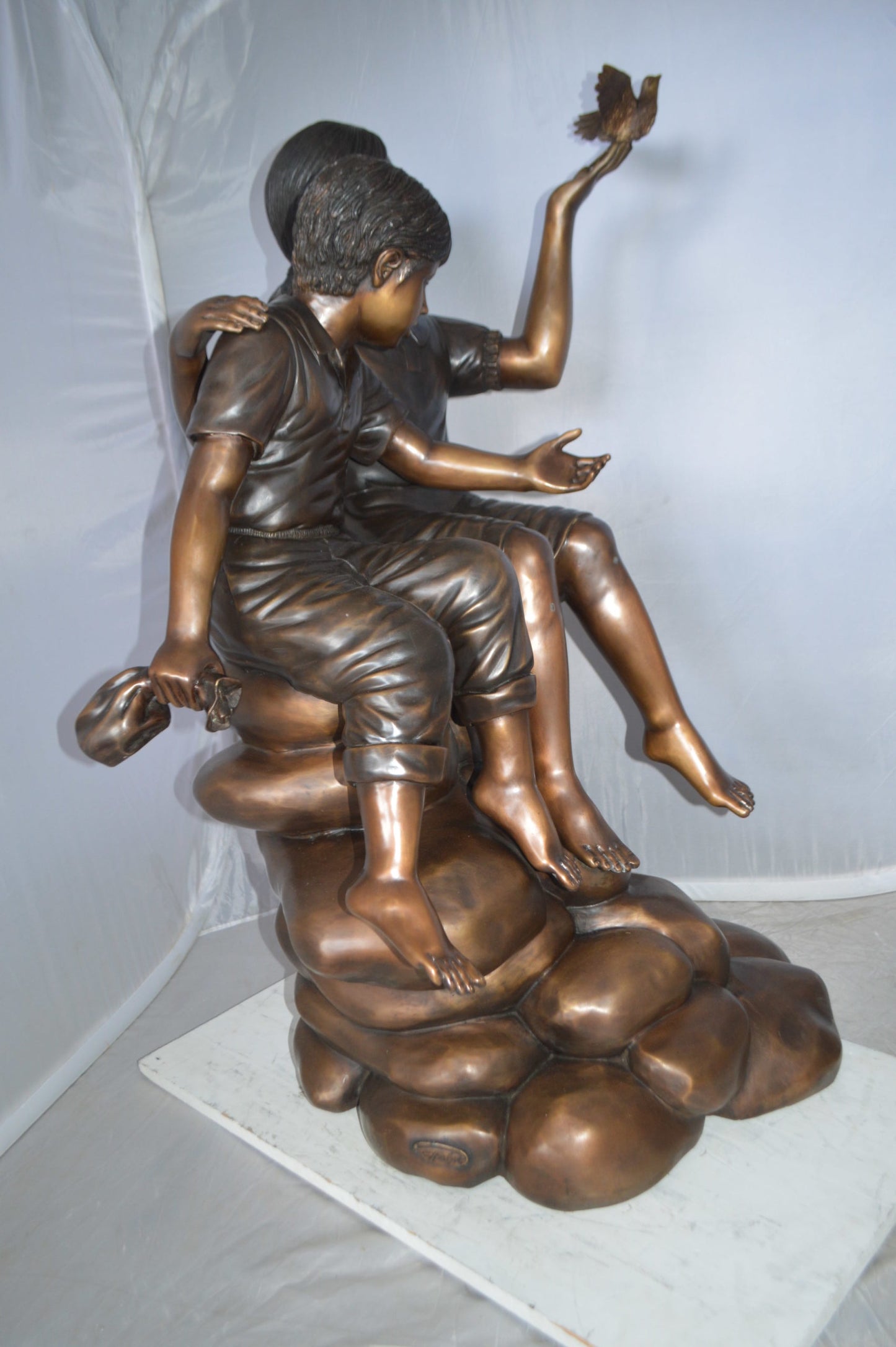 Two Kids on Rocks with a Bird Bronze Statue -  Size: 36"L x 30"W x 44"H. 